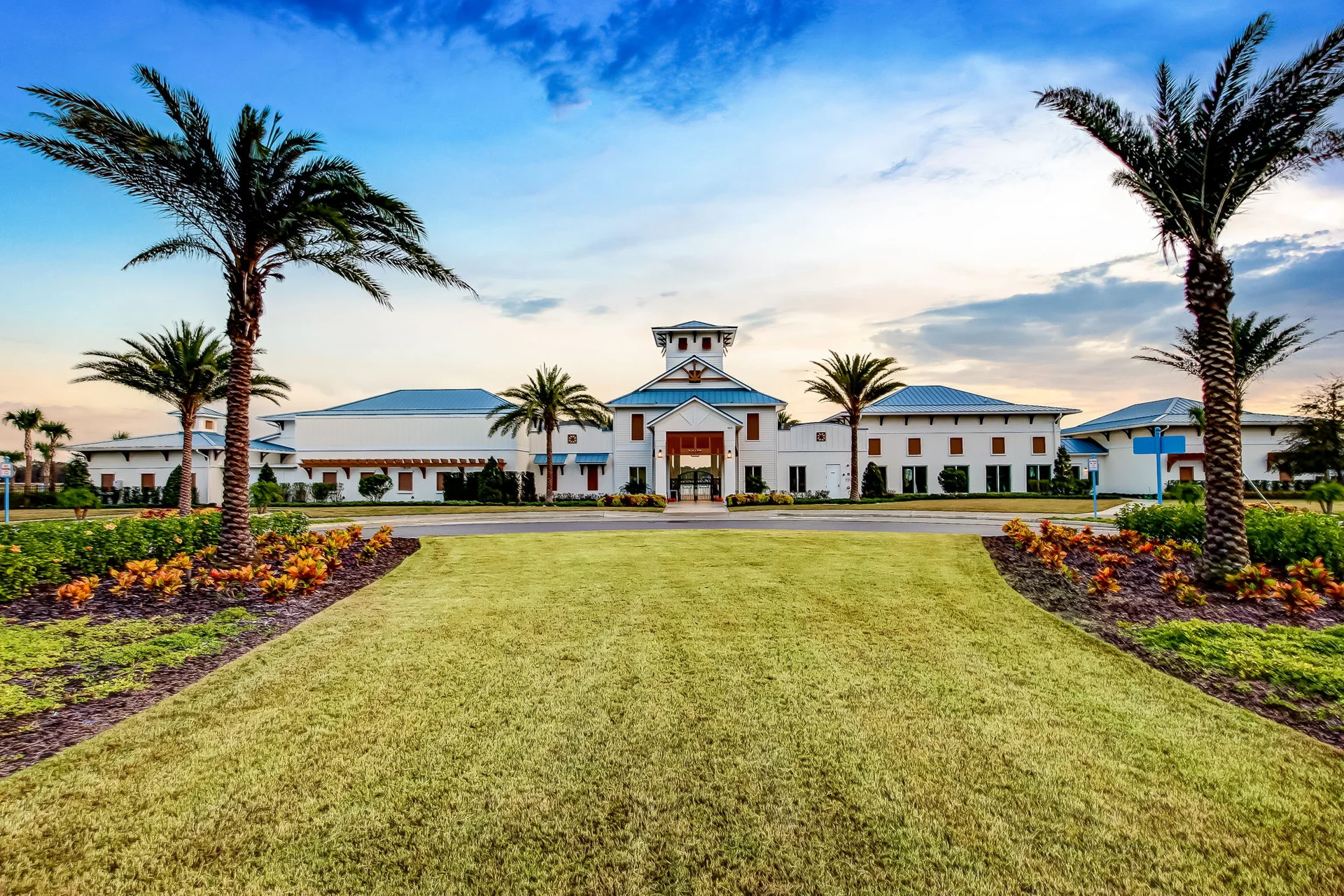 Beachwalk Club clubhouse entrance surrounded by palms